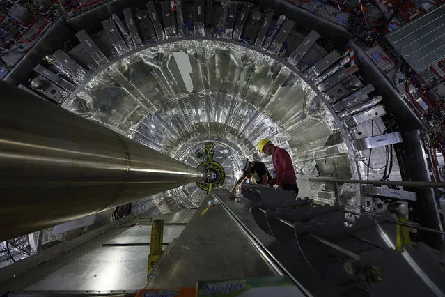 In this undated picture publicly provided by the European Organization for Nuclear Research, CERN, employees and scientists prepare the upgrading  of one of the four main experiments on the world’s biggest atom smasher in the hope it will help them discover previously unknown particles or physical properties at CERN near Geneva.  Officials at  CERN, said the operations the equivalent of a “heart transplant” for the CMS experiment. CMS was key to confirming the existence of the Higgs boson particle in 2012. (Photo by CERN via AP Photo)