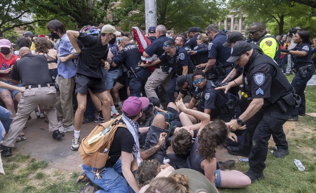 Pro-Palestinian demonstrators clash with police after replacing an American flag with a Palestinian flag Tuesday, April 30, 2024 at UNC-Chapel Hill. Police removed a “Gaza solidarity encampment” earlier Tuesday morning. (Photo by Travis Long/News Observer)