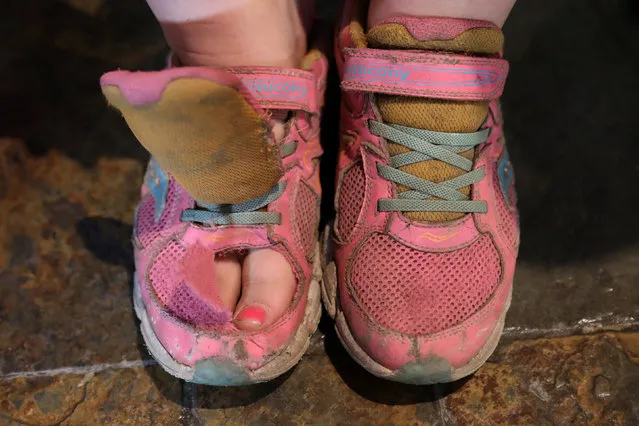 Shannon Winckler from Wheaton, Illinois, sits before her shoes are judged during the Odor-Eater's Rotten Sneaker Contest at Ripley's Believe It or Not! Times Square in New York, U.S., March 28, 2017. (Photo by Shannon Stapleton/Reuters)