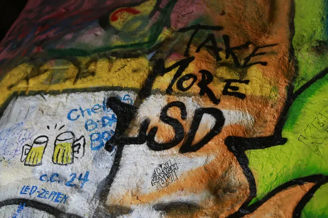 Graffiti with alcohol and drugs themes are seen inside the Corral Canyon Cave in Malibu, Calif., Friday, May, 6, 2016. Fans of the band who have marked up a scenic cave on the California coast with psychedelic graffiti will have to find another place to spray out their love for front man Jim Morrison. (Photo by Damian Dovarganes/AP Photo)