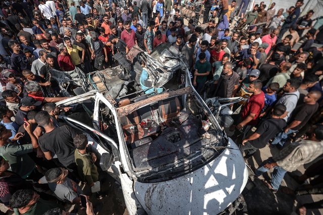 Palestinians inspect the destroyed vehicle after Israeli attack, in Deir al-Balah, Gaza on June 4, 2024. The Israeli army attacked a Palestinian vehicle in Deir al-Balah city in the central Gaza Strip. As a result of the attack, it was reported that there were dead and wounded. (Photo by Ali Jadallah/Anadolu via Getty Images)