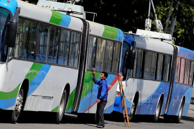 A man cleans a trolleybus in central Pyongyang, North Korea May 8, 2016. (Photo by Damir Sagolj/Reuters)