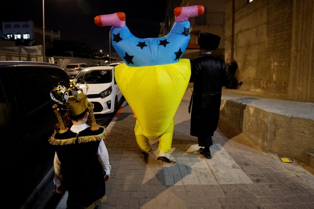 Ultra-Orthodox Jewish people wear costumes during the Jewish holiday of Purim, a celebration of the Jews' salvation from genocide in ancient Persia, as recounted in the Book of Esther, in Ashdod, Israel on March 6, 2023. (Photo by Amir Cohen/Reuters)