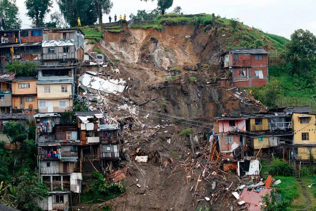View of a landslide that destroyed several houses in Manizales, Colombia, Wednesday, April 19, 2017. At least seven people are dead after intense rains provoked several landslides in a mountainous, coffee- growing part of Colombia. (Photo by Maria Luisa Garcia/AP Photo) 