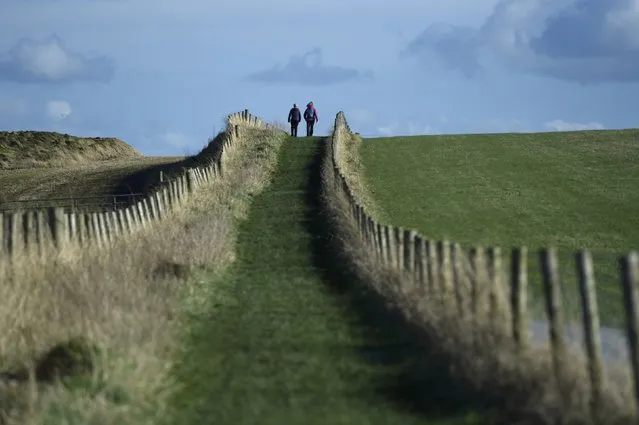 People go for a walk along the Causeway Coastal route in Ballintoy, Northern Ireland February 27, 2017. (Photo by Clodagh Kilcoyne/Reuters)