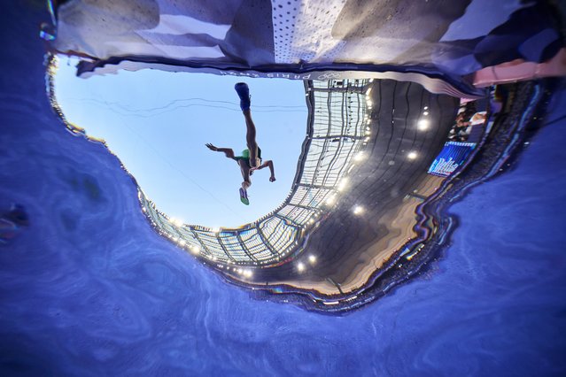 In this photo taken with a remote camera, an athlete clears the water jump during the men's 3000-meter steeplechase round 1 heat at the 2024 Summer Olympics in Saint-Denis, France, Monday, August 5, 2024. (Photo by Adam Pretty/Pool Photo via AP Photo)