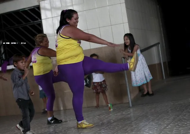 Hazel Castillo, takes part in an aerobics class next to her son Heiner Jaen, in Los Guidos de Desamparados July 23, 2015. (Photo by Juan Carlos Ulate/Reuters)