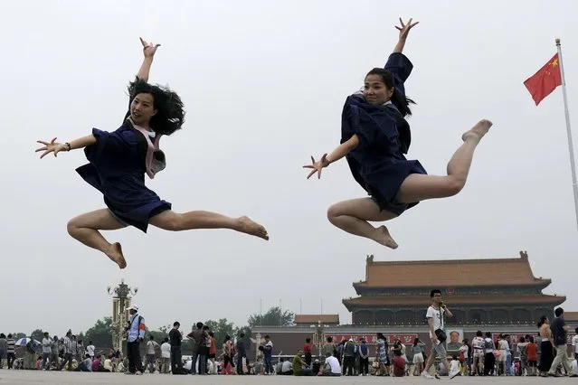 Graduates jump as they pose for photographs in front of the Tiananmen Gate and the giant portrait of late Chinese Chairman Mao Zedong, on the Tiananmen Square in Beijing, June 19, 2014. (Photo by Reuters/Stringer)