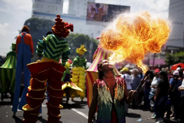 A performer spits fire during the opening parade of the festivities of El Divino Salvador del Mundo (The Divine Savior of The World), patron saint of the capital city of San Salvador, El Salvador August 1, 2015. (Photo by Jose Cabezas/Reuters)