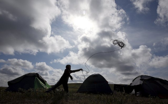 A boy, one of the children of local herders, throws lasso at a reindeer camping ground, some 200 km (124 miles) northeast of Naryan-Mar, the administrative centre of Nenets Autonomous Area, far northern Russia, August 2, 2015. (Photo by Sergei Karpukhin/Reuters)