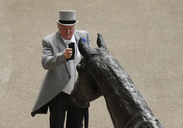 Britain Horse Racing, Royal Ascot, Ascot Racecourse on June 15, 2016. Racegoer takes a photo. (Photo by Andrew Boyers/Reuters/Action Images/Livepic)