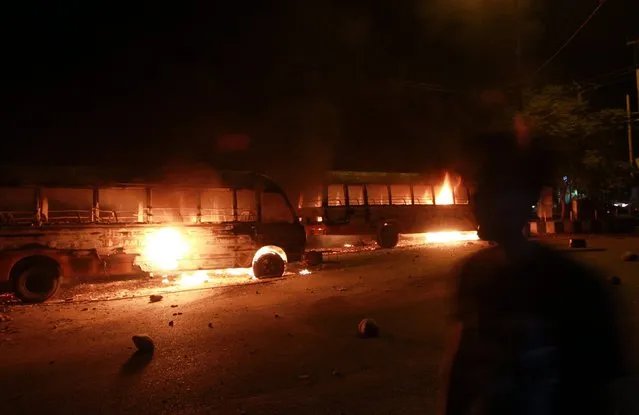 Vehicles were allegedly set ablaze by protesters in Jammu, the winter capital of Kashmir, India, 14 June 2016. According to the news reports, protesters gathered and clashed with the police after some youngsters beat two youths of the other community whom they blamed for smashing the window panes and doors of a local temple. The protestors torched a school vehicle and surrounded the local police station. (Photo by Jaipal Singh/EPA)
