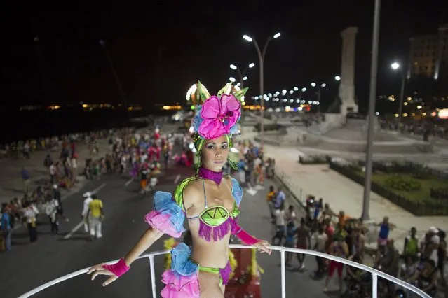 A reveler waits for the beginning of a carnival parade in Havana, Cuba August 7, 2015. (Photo by Alexandre Meneghini/Reuters)