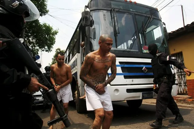 Members of the Mara Salvatrucha gang are guarded by policemen upon their arrival at the Quezaltepeque jail in Quezaltepeque, El Salvador, March 29, 2016. (Photo by Jose Cabezas/Reuters)