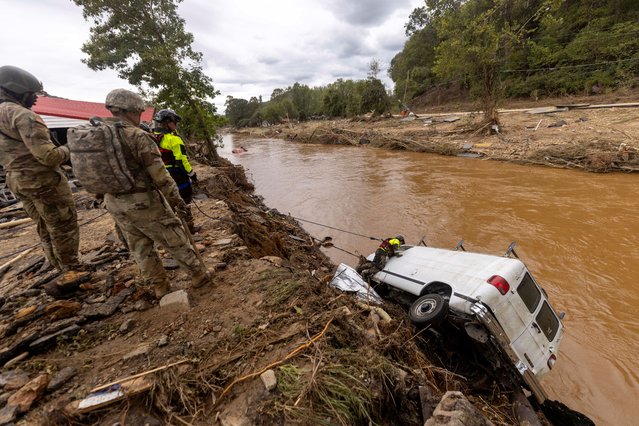 A search and rescue team out of Atlantic Beach examines a van swept into the river in Swannanoa, by flooding from Helene, in North Carolina, September 29, 2024.  (Photo by Travis Long/The News & Observer)