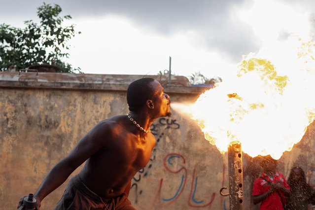 A fire breather performs during a slum party in Oworonshoki district of Lagos, Nigeria, 24 September, 2024. (Photo by Emmanuel Adegboye/EPA/EFE)