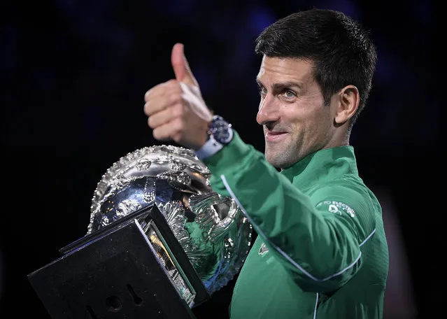 Serbia's Novak Djokovic gestures as he holds the Norman Brookes Challenge Cup after defeating Austria's Dominic Thiem in the final of the Australian Open tennis championship in Melbourne, Australia, Monday, February 3, 2020. (Photo by Andy Brownbill/AP Photo)