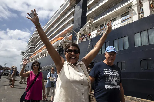 Excited passengers disembark from the MS Westerdam cruise ship after being stranded for two weeks, now docked on February 14, 2020 in Sihanoukville, Cambodia. The ship is completely free from the Coronavirus (COVID-19.) but was turned away from five other Asian ports, it departed Hong Kong February 1st with 1,455 passengers and 802 crew on board. Another cruise ship is in quarantine in Japan with more than 200 infections. The Coronavirus cases rise to more than 64,000 people, total number of deaths is approximately 1,383. (Photo by Paula Bronstein/Getty Images)