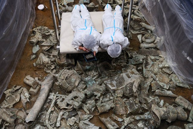 Archaeologists work at No. 8 sacrificial pit of the Sanxingdui Ruins site on June 28, 2022 in Guanghan, Deyang City, Sichuan Province of China. (Photo by Zhang Lang/China News Service via Getty Images)