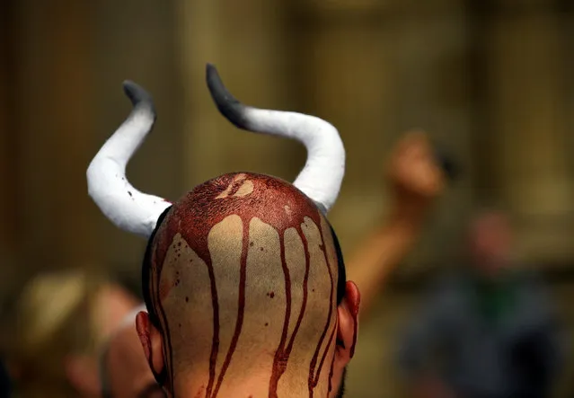 An animal rights protester covered in fake blood demonstrate for the abolition of bull runs and bullfights a day before the start of the famous running of the bulls San Fermin festival in Pamplona, northern Spain, July 5, 2016. (Photo by Eloy Alonso/Reuters)
