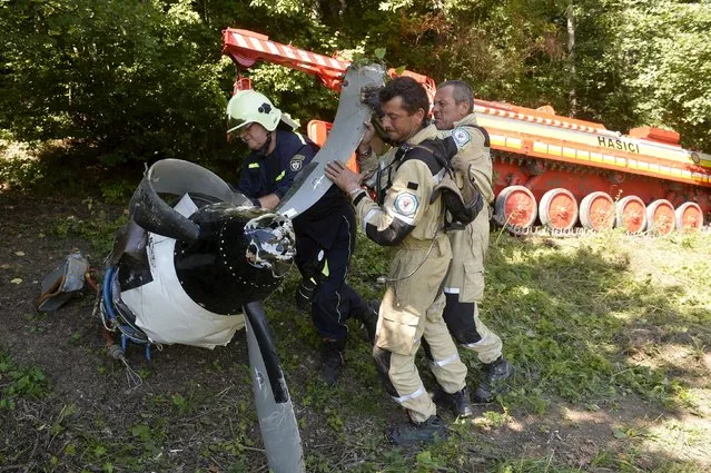 Authorities investigate the crash site of one of the two Czech-made L-410 planes near the village of Cerveny Kamen, Slovakia, August 21, 2015. (Photo by Radovan Stoklasa/Reuters)