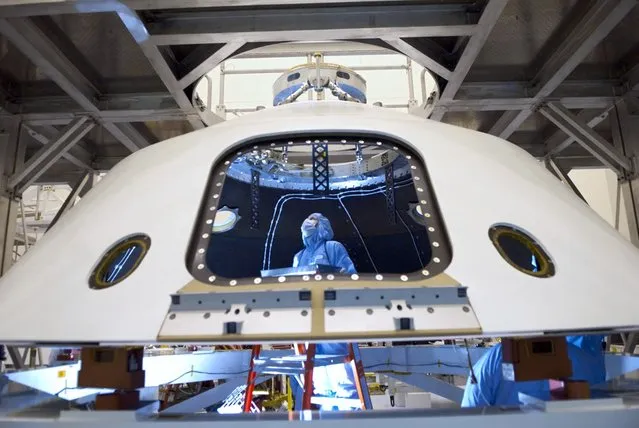 In the Payload Hazardous Servicing Facility at NASA's Kennedy Space Center in Florida, technicians process the backshell for the Mars Science Laboratory. The spacecraft's backshell carries the parachute and several components used during later stages of entry, descent and landing of MSL's rover, Curiosity. (Photo by NASA/Jim Grossmann)