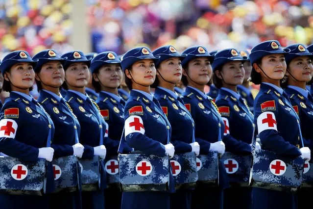 Military nurses look from atop a truck towards Chinese President and other leaders during the military parade marking the 70th anniversary of the end of World War Two, in Beijing, China, September 3, 2015. (Photo by Damir Sagolj/Reuters)
