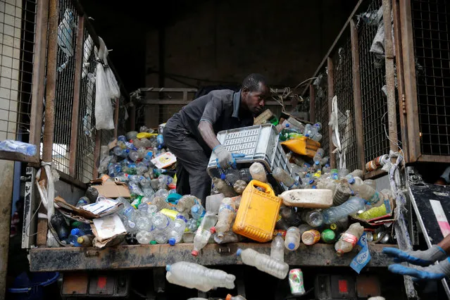 A man moves waste collected from homes from the back of a truck at the Wecycler waste recycling centre in Ebutte meta district in Lagos, Nigeria July 28, 2016. (Photo by Akintunde Akinleye/Reuters)