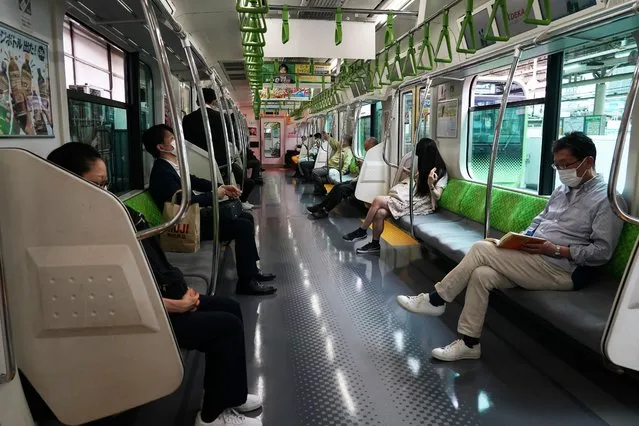 Few people wearing face masks are seen on a JR Yamanote Line amid the coronavirus pandemic on May 12, 2020 in Tokyo, Japan. (Photo by Etsuo Hara/Getty Images)