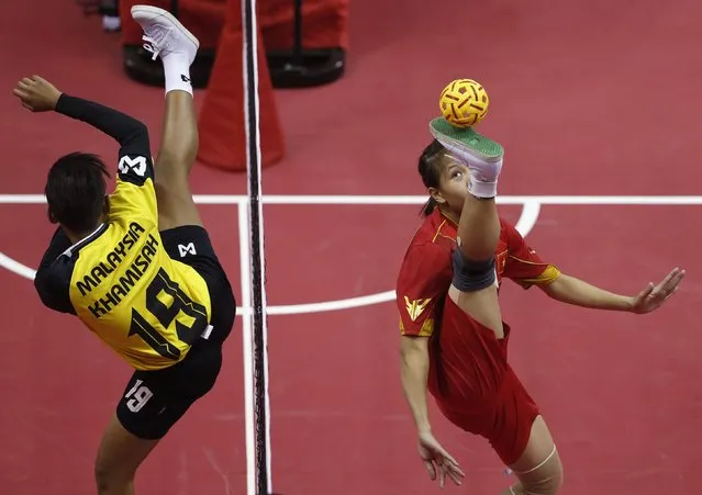Vietnam's Nguyen Thi Quyen (R) strikes the ball as Malaysia's Khamis Kamisah defends during the Women's Double's Sepaktakraw match at the Bucheon Gymnasium during the 17th Asian Games in Incheon September 20, 2014. (Photo by Olivia Harris/Reuters)