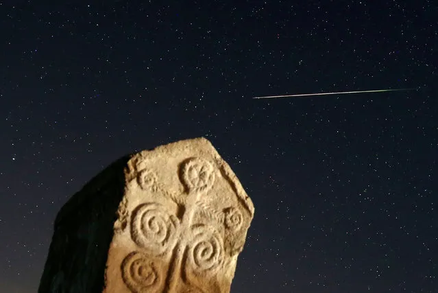 A meteor streaks past stars in the night sky above medieval tombstones in Radmilje near Stolac, south of Sarajevo, Bosnia and Herzegovina, August 12, 2016. (Photo by Dado Ruvic/Reuters)