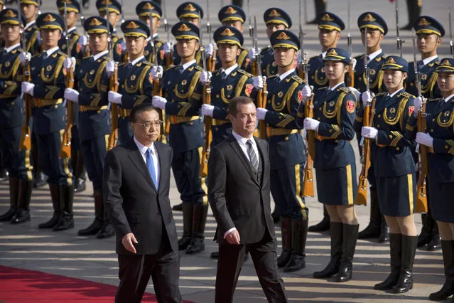 Chinese Premier Li Keqiang, left, and Russian Prime Minister Dmitry Medvedev review an honor guard during a welcome ceremony at the Great Hall of the People in Beijing, Wednesday, November 1, 2017. (Photo by Mark Schiefelbein/AP Photo)
