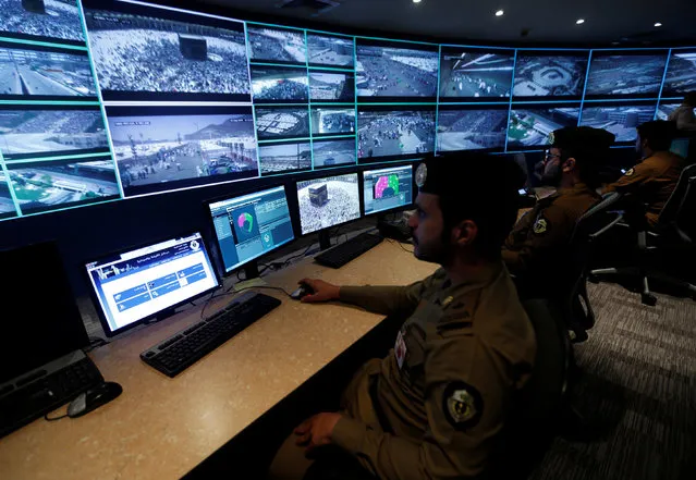 Saudi policemen look at monitor screens showing footage from cameras set up around the holy places, during a tour for journalists, on the second day of Eid al-Adha in Mina near the holy city of Mecca  September 13, 2016. (Photo by Ahmed Jadallah/Reuters)