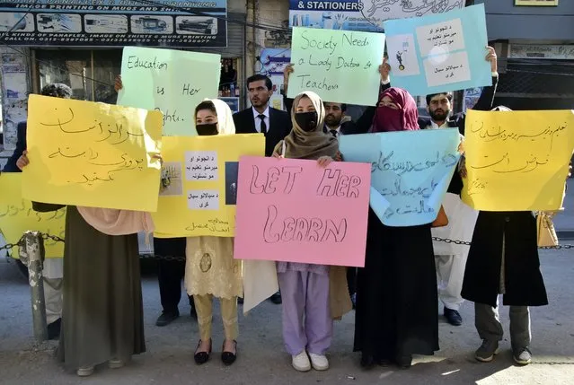 Afghan university students chant slogans and hold placards during a protest against the ban on university education for women, in Quetta, Pakistan, Saturday, December 24, 2022. (Photo by Arshad Butt/AP Photo)