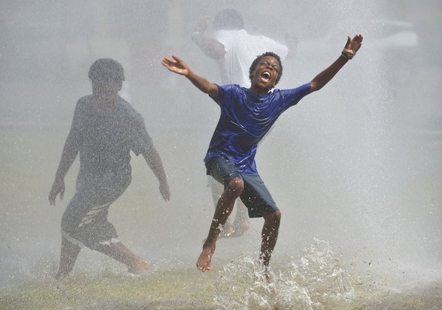 Children cool off during the Benton Harbor Department of Public Safety's Spray & Play held at the Pete Mitchell City Center Park in downtown Benton Harbor, Mich., on Tuesday, June 24, 2025. (Photo by Don Campbell/The Herald-Palladium via AP Photo)