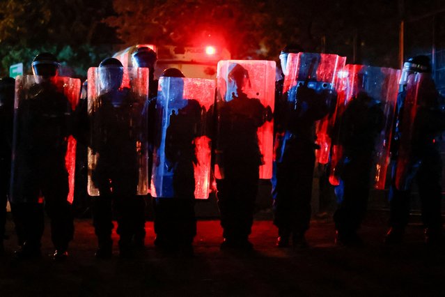 Police officers line up during a second night of riots, in Ballymena, Northern Ireland, on June 10, 2025. (Photo by Clodagh Kilcoyne/Reuters)