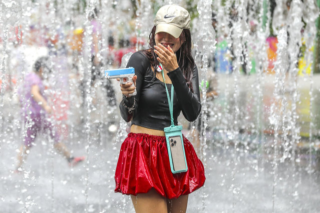 People use large water guns to spray each other as they celebrate the annual Songkran festival in Bangkok, Thailand on April 14, 2025. Thailand celebrated the Thai traditional New Year, called Songkran in Thai and also known as ëthe water festivalí, on 13 April, with festivities going on on throughout the weekend. During Songkran, people celebrate the New Year by splashing water to each other as a sign of washing away sins and bad luck from the previous year. People across Thailand celebrate the New Year with parties and water related activities throughout the weekend. (Photo by Diego Azubel/Matrix Images)
