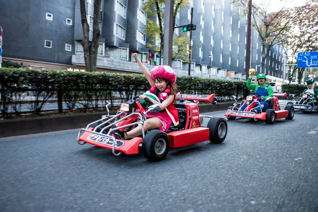 Participants drive around Tokyo for the Real Mario Kart event in Tokyo on November 16, 2014 in Tokyo, Japan. The organizer calls for participants to this event held about once a month on Facebook, and Akiba Kart offers rental karts that can be driven on public streets. (Photo by Keith Tsuji/Getty Images)