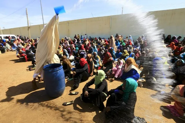 Shaq Boshraa, a spiritual healer, sprinkles water during a sermon at a yard in Khartoum, Sudan, October 30, 2015. (Photo by Mohamed Nureldin Abdallah/Reuters)