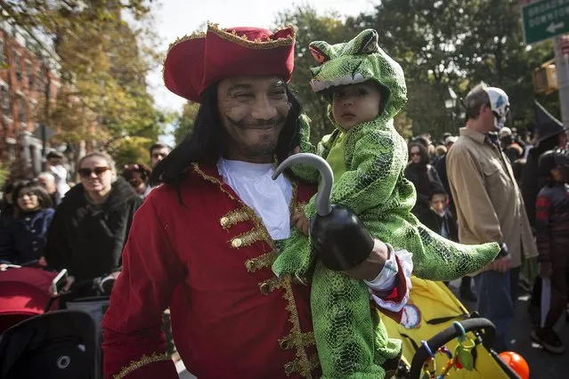 People take part in the Children's Halloween day parade at Washington Square Park in the Manhattan borough of New York October 31, 2015. (Photo by Carlo Allegri/Reuters)