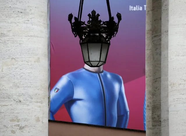 A poster depicting an Italian athlete that had competed during the Pyeongchang Olympic games is seen framed by the column outside Saint Peter's Square at the Vatican as Pope Francis leads the Angelus prayer March 11, 2018. (Photo by Max Rossi/Reuters)