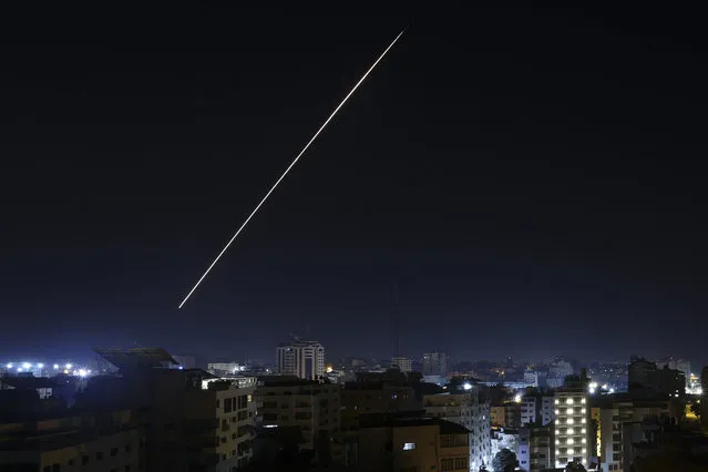 A long exposure shows a light trail from a projectile fired from Gaza City as Israel launched air strikes on the Palestinian enclave early on January 27, 2023. Israel launched air strikes on Gaza on January 27 in response to militant rocket fire from the Palestinian enclave, as tensions rise following the deadliest army raid on the occupied West Bank in years. (Photo by Mohammed Abed/AFP Photo)