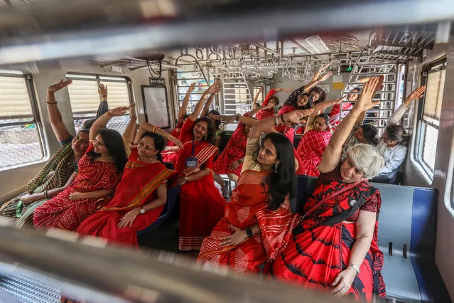 Indian women perform yoga inside a local train on International Women’s Day, organised by Heal-Station in association with Western Railway, in Mumbai, India, 08 March 2023. International Women's Day (IWD) is observed annually on 08 March worldwide to highlight women's rights, as well as issues such as violence and abuse against women. The theme of IWD 2023 is “DigitALL: Innovation and technology for gender equality”. According to the United Nations, 37 percent of women around the world do not use the internet, leading to a digital gender gap that widens economic and social inequalities. (Photo by Divyakant Solanki/EPA/EFE)
