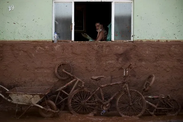 A man works on the cleaning of a house flooded with mud after a dam, owned by Vale SA and BHP Billiton Ltd burst, in Barra Longa, Brazil, November 7, 2015. The death toll from two collapsed dams at a Brazilian mine will surely rise in coming days, a local mayor said on Saturday, as up to 10 residents of the nearest village remain missing in addition to 13 miners. So far one worker has been confirmed dead in what the governor of mineral-rich Minas Gerais described as the state's worst environmental disaster. (Photo by Ricardo Moraes/Reuters)