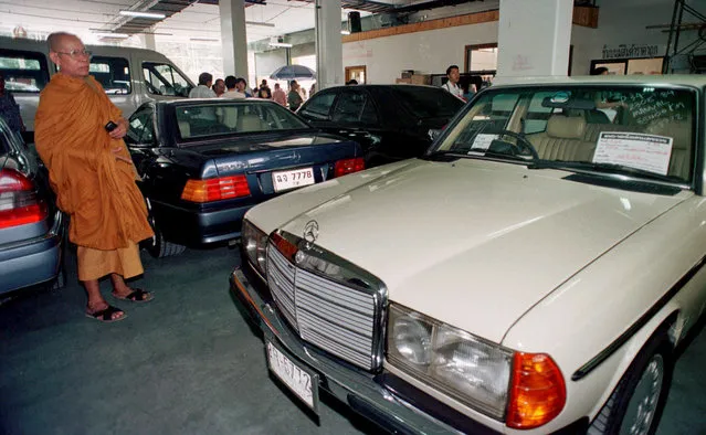 In this November 29, 1997, file photo, a Buddhist monk inspects a Mercedes Benz offered at a drastically reduced price at the weekend market in Bangkok, Thailand. Asian governments and economies have recovered from the financial meltdown that spread through much of Asia 20 years ago, but many in people Thailand, the epicenter of the crisis, recall painful memories of living through it and lost everything. (Photo by Thaksina Khaikaew/AP Photo)