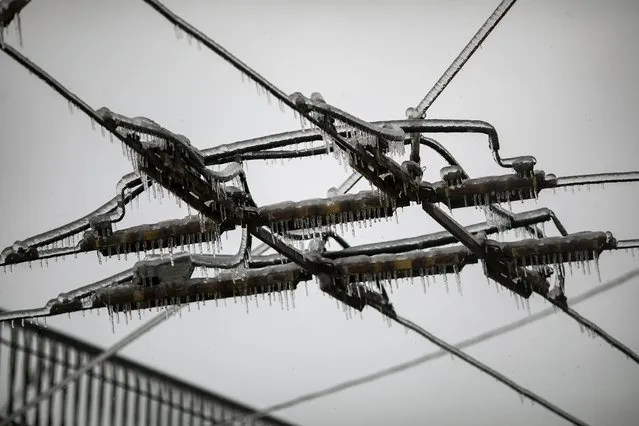 Trolleybus' power lines covered in ice on a street after an ice storm in Vladivostok, Russia, Friday, November 20, 2020. (Photo by Aleksander Khitrov/AP Photo)