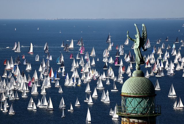 The Victory Lighthouse in Trieste, Italy, overlooks boats taking part in the Barcolana, the world’s largest sailing regatta on October 12, 2025. (Photo by Yara Nardi/Reuters)