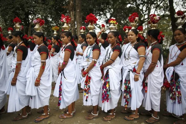 Tharu performers dressed in traditional attire participate in a parade marking an Elephant Festival event at Sauraha in Chitwan, about 170 km (106 miles) south of Kathmandu December 26, 2014. (Photo by Navesh Chitrakar/Reuters)