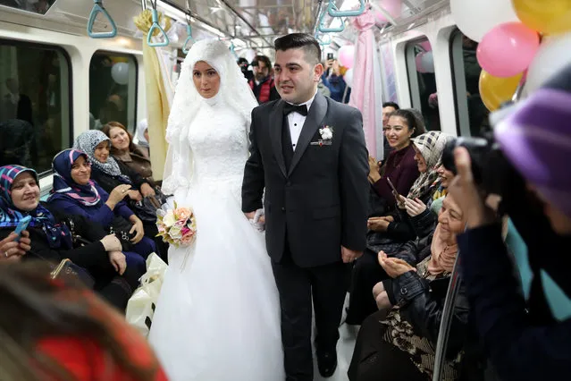 Alper Odabas (C-R) and Yesim Demiray (C-L) on the subway to travel to their wedding ceremony at another Istanbul Subway in Istanbul, Turkey, 30 October 2016. The Istanbul Metropolitan Municipality announced that it will allow subway stations to be used as venues for wedding ceremonies. (Photo by Tolga Bozoglu/EPA)