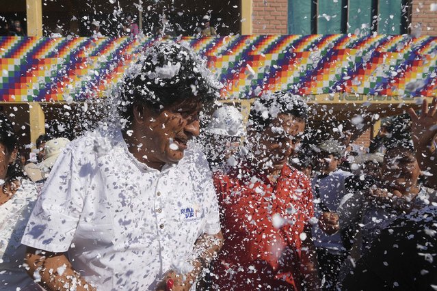 Supporters throw confetti on former President Evo Morales before he voted in presidential and legislative elections in the Chapare region of Bolivia on Sunday, August 17, 2025. Jorge Saenz/AP Photo)